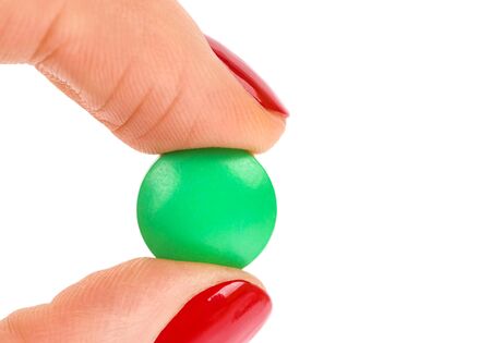 Pills in woman hand isolated on white backgroundの写真素材