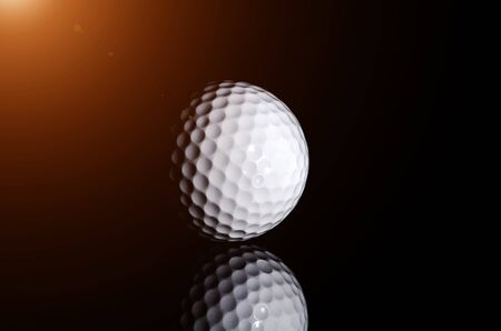 Golf ball on black backgroundの写真素材