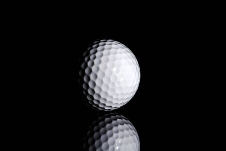 Golf ball on black backgroundの写真素材