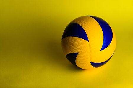 volleyball ball on yellow background.の写真素材