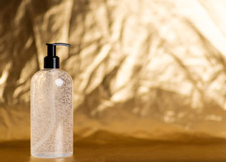 Hand sanitizer. Gel for hand hygiene. Antiseptic Hand Wash. Hand Alcohol Sanitizer. pump bottle isolated over golden background. Corona virus protection. covid-19, Coronavirus pandemic.の写真素材