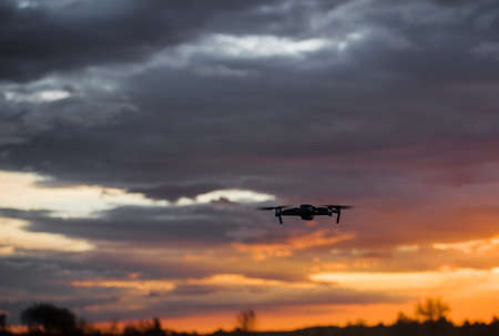 drone quadcopter with digital camera at beautiful sunrise sky.の写真素材