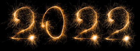 Happy New Year 2022. Number 2022 written sparkling sparklers isolated on black background.の写真素材