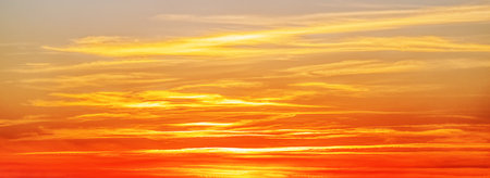 Beautiful sunset sky above clouds with dramatic light. cabin view from airplane.