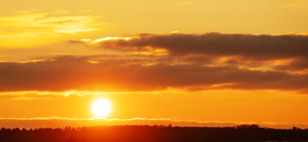 Golden Sunset with sun and clouds with dramatic sky with sun raysの写真素材