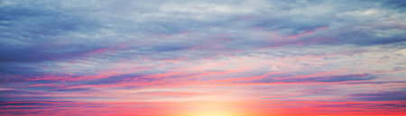 Real amazing panoramic sunrise or sunset sky with gentle colorful cloudsの写真素材