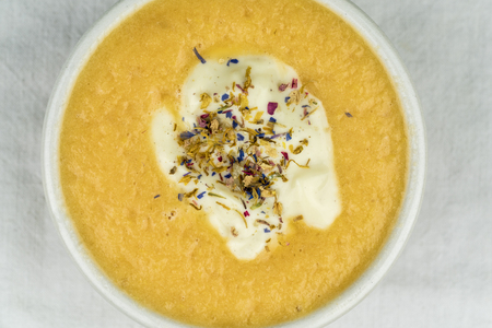 Overhead view of healthy smoothie bowl garnished with herbs