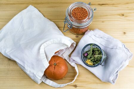 Overhead view of ripe tangerine on a wooden table with lentils and tea leaves. No waste concept.の写真素材
