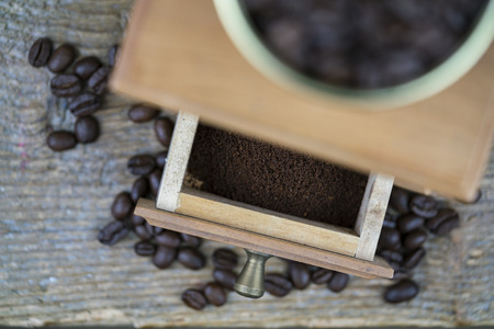 Coffee grinder viewed from above with focus to the open drawer with ground beans ready to make a fresh cup of coffeeの写真素材