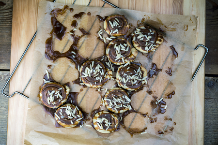 Half eaten batch of homemade cinnamon rolls cooling on a wire rack in the kitchen viewed from above with several missingの写真素材