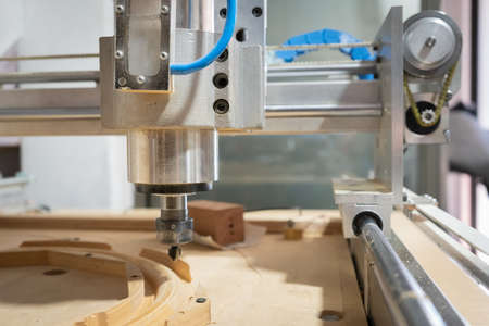 milling machine carving a piece of wood in the workshop