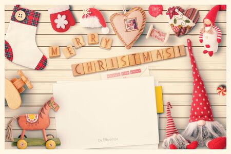 Christmas Greeting Card with Xmas Elements on White Wooden Background. Retro Style. Space for Text. Vintage Toned.の写真素材