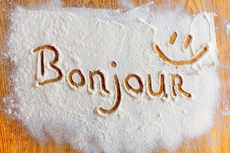 Bonjour word written in flour closeup.の写真素材
