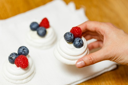 Meringue dessert with fresh berries and whipped creamの写真素材