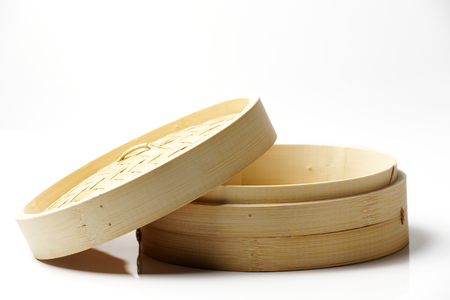 Chinese bamboo steamer closeup. Isolated on white background.の写真素材