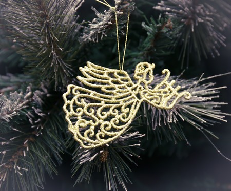 gold angel hanging on eve, Christmas backgroundの写真素材