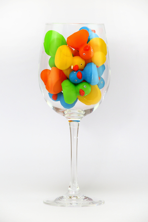 colorful flock of duckling in glass isolatedの写真素材