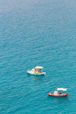 summer seascape with small blue fishernan boats