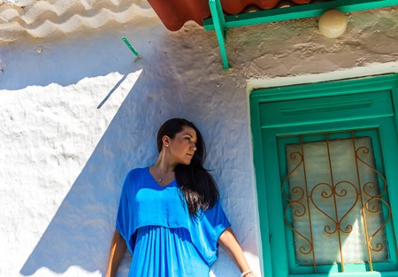 beautiful young brunet woman in blue clothesの写真素材