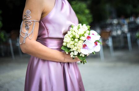bride in rose dress hold a bouquet of white rosesの写真素材