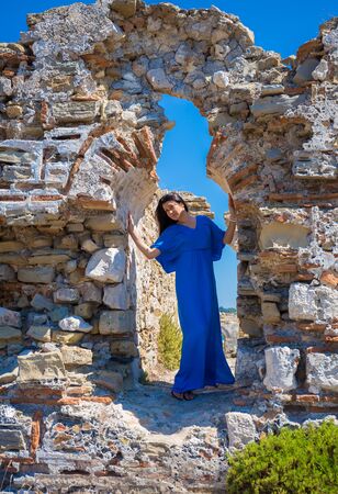beautiful young brunet woman in blue clothesの写真素材