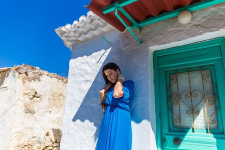 beautiful young brunet woman in blue clothesの写真素材