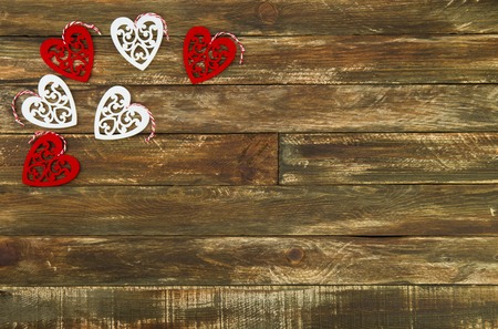 Red and white Hearts Hanging over Brown Wooden Background. Romantic Decoration For Valentines Day. Rustic, Retro Or Vintage Styleの写真素材