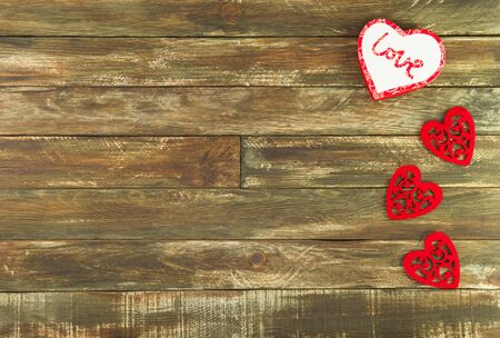 Red and white Hearts Hanging over Brown Wooden Background. Romantic Decoration For Valentines Day. Rustic, Retro Or Vintage Styleの写真素材