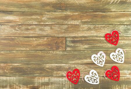 Red and white Hearts Hanging over Brown Wooden Background. Romantic Decoration For Valentines Day. Rustic, Retro Or Vintage Styleの写真素材