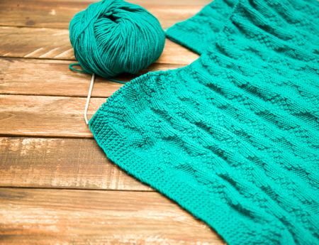 ball of yarn and knitting needles on a wooden surface. Top viewの写真素材