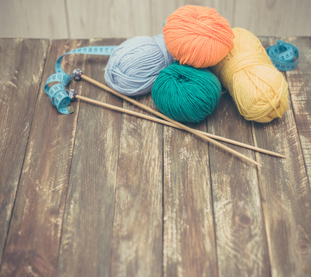 Yarn with wooden knitting needles for knitting on wooden backgroundの写真素材