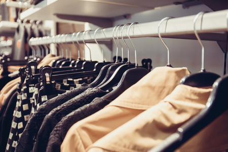 different clothing on hangers in shopの写真素材