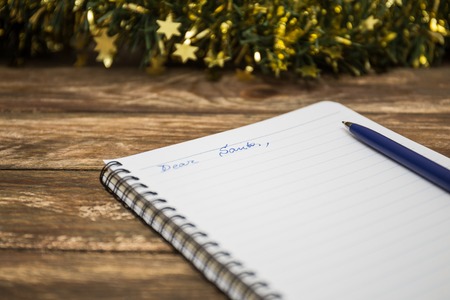 wooden background with notebook and penの写真素材