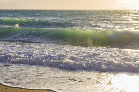 Sea waves at the coastline on a sunny dayの写真素材
