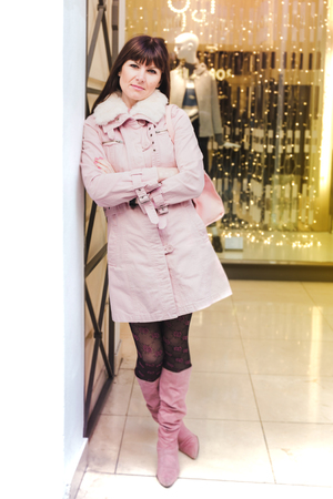 Portrait of a Stylish Pretty Young Woman in Autumn Fashion walking the city, near the window shopの写真素材