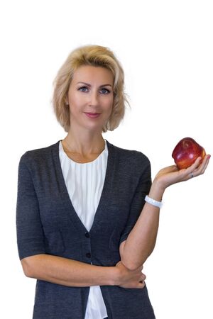 business portrait of a nutritionist caucasian female with apple on white backgroundの写真素材