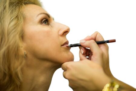backstage of making up of a model on white backgroundの写真素材