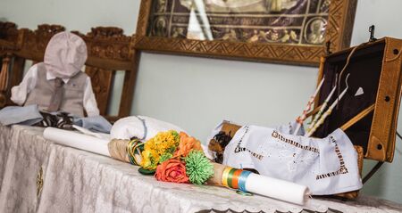 greek Orthodox christening objects - baby clothes, shoes, baptism oil, soap and candlesの写真素材