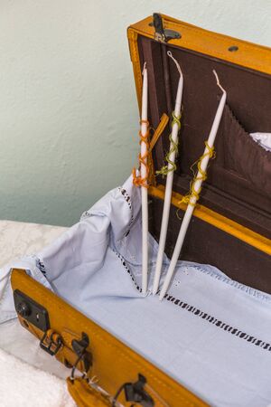 greek Orthodox christening objects - baby clothes, shoes, baptism oil, soap and candlesの写真素材