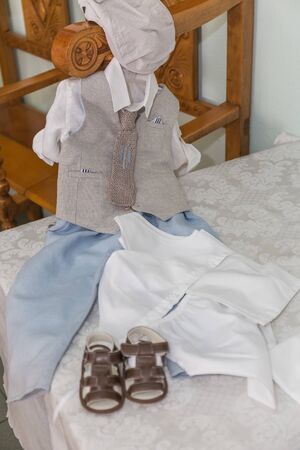 greek Orthodox christening objects - baby clothes, shoes, baptism oil, soap and candlesの写真素材