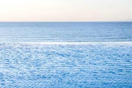 Beautiful view of Infinity Swimming Pool with tropical sea outlookの写真素材