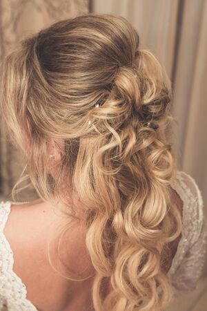 Hair stylist makes the bride before weddingの写真素材