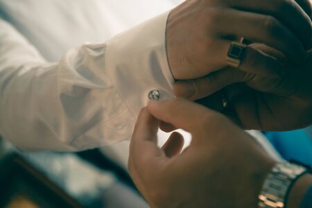 The helps groom to put on cufflinks close upの写真素材