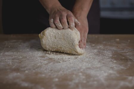 woman hands kneading bread doughの写真素材