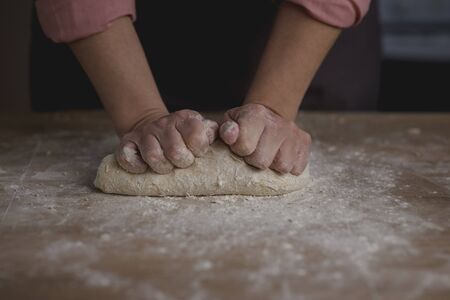 woman hands kneading bread doughの写真素材
