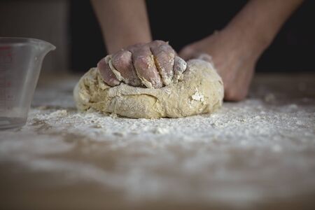 woman hands kneading bread doughの写真素材