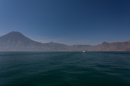 Lake Atitlan boat and volcanoesの写真素材