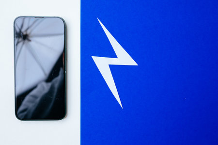 Blue Lightning App And Reflective Screen. Smartphone Next To Blue Lightning And Umbrella Lightの写真素材