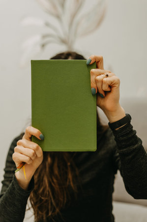 Creative Woman Journals With Serenity. Quiet Woman Displaying Artistic Expression Indoorsの写真素材