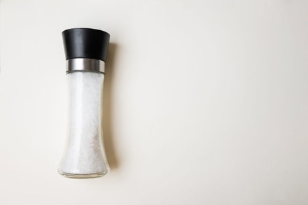 Modern Kitchen Countertop Accessory Showcasing Transparent Salt Grinder Filled With Coarse Sea Saltの写真素材